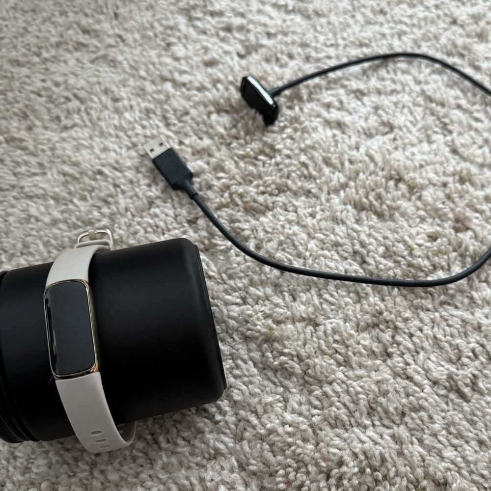 Black and Cream Fitness Tracker with Charger